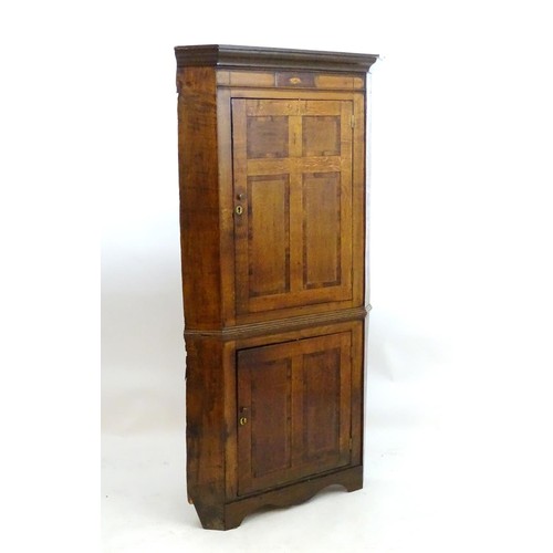 1718A - A mid / late 18thC oak double corner cupboard with a moulded cornice above a satinwood inlaid frieze... 