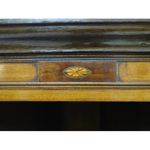 1718A - A mid / late 18thC oak double corner cupboard with a moulded cornice above a satinwood inlaid frieze... 