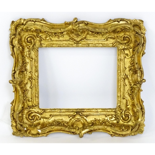 2251 - A 19thC gilt composite frame with swept and pierced detail. Rebate approx. 11 1/4