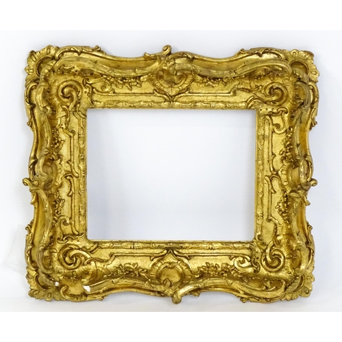 2251 - A 19thC gilt composite frame with swept and pierced detail. Rebate approx. 11 1/4