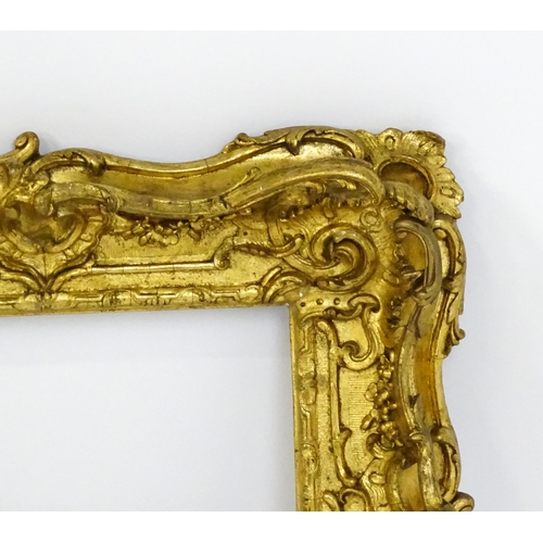 2251 - A 19thC gilt composite frame with swept and pierced detail. Rebate approx. 11 1/4