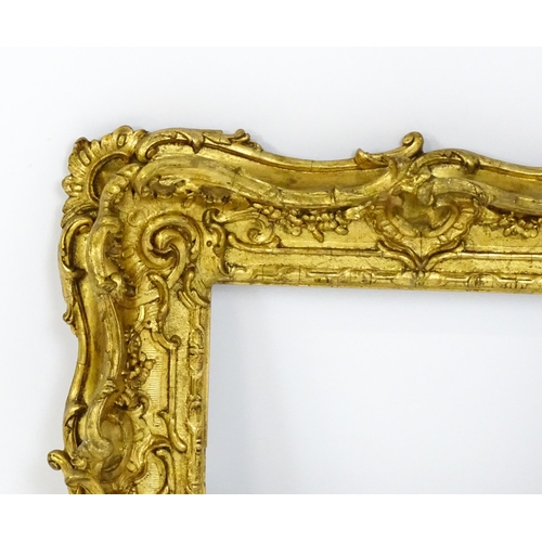 2251 - A 19thC gilt composite frame with swept and pierced detail. Rebate approx. 11 1/4