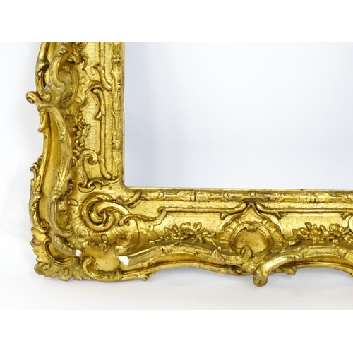 2251 - A 19thC gilt composite frame with swept and pierced detail. Rebate approx. 11 1/4