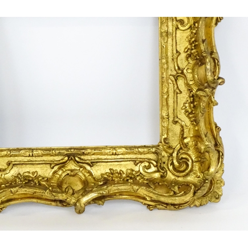 2251 - A 19thC gilt composite frame with swept and pierced detail. Rebate approx. 11 1/4