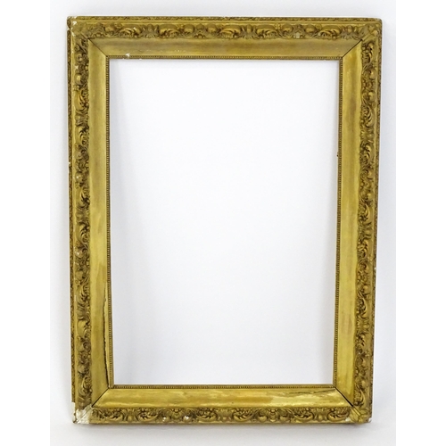 2255 - An early 20thC gilt composite frame with scrolling foliate detail. Rebate approx. 25 3/4