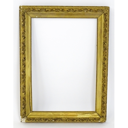 2255 - An early 20thC gilt composite frame with scrolling foliate detail. Rebate approx. 25 3/4