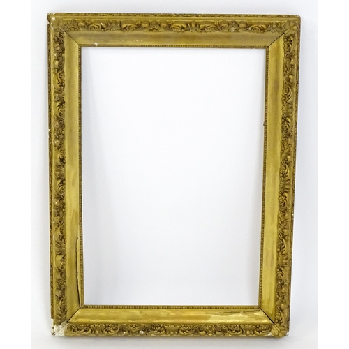 2255 - An early 20thC gilt composite frame with scrolling foliate detail. Rebate approx. 25 3/4