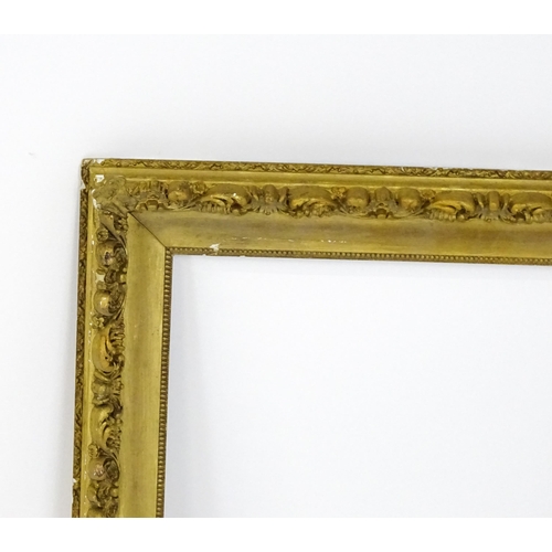 2255 - An early 20thC gilt composite frame with scrolling foliate detail. Rebate approx. 25 3/4