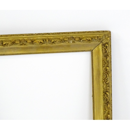 2255 - An early 20thC gilt composite frame with scrolling foliate detail. Rebate approx. 25 3/4