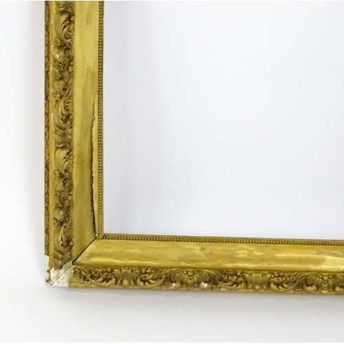 2255 - An early 20thC gilt composite frame with scrolling foliate detail. Rebate approx. 25 3/4