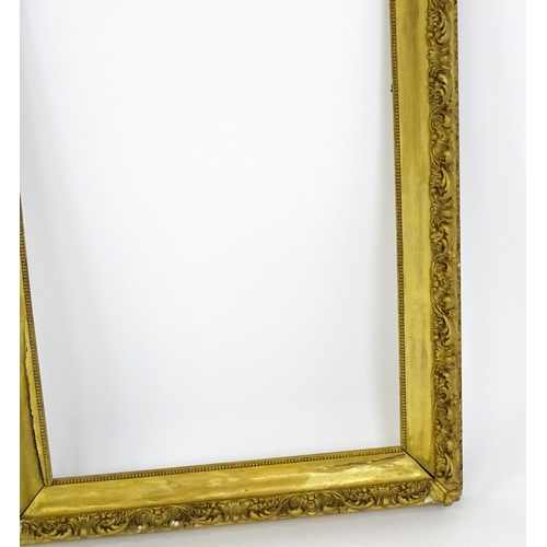 2255 - An early 20thC gilt composite frame with scrolling foliate detail. Rebate approx. 25 3/4