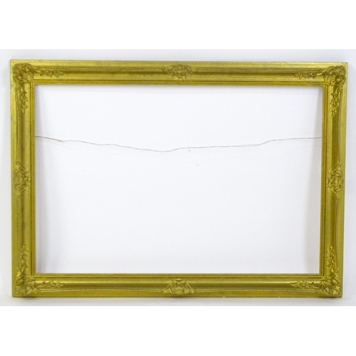 2257 - A 20thC gilt composite frame with swept detail. Rebate approx. 24