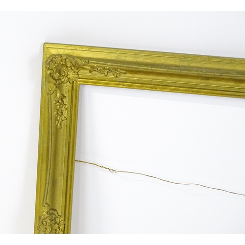 2257 - A 20thC gilt composite frame with swept detail. Rebate approx. 24