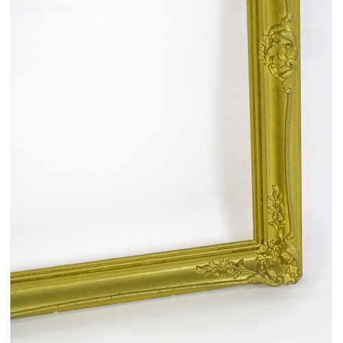 2257 - A 20thC gilt composite frame with swept detail. Rebate approx. 24