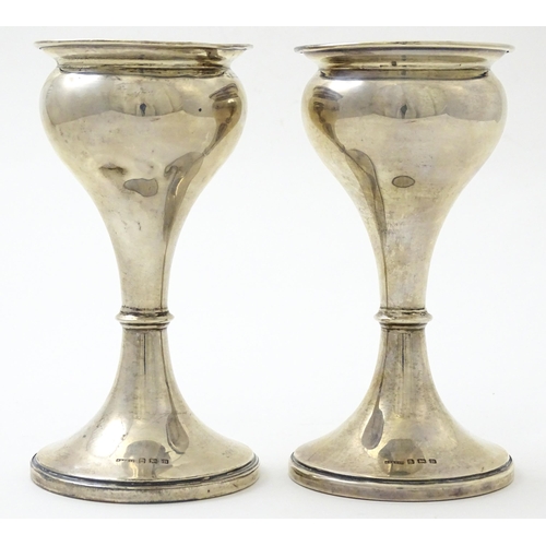 633 - A pair of silver vases hallmarked Birmingham 1926, maker S. Blanckensee & Sons Ltd. Approx. 6