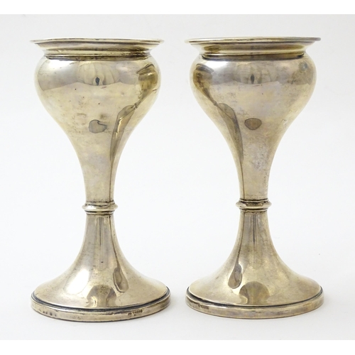 633 - A pair of silver vases hallmarked Birmingham 1926, maker S. Blanckensee & Sons Ltd. Approx. 6