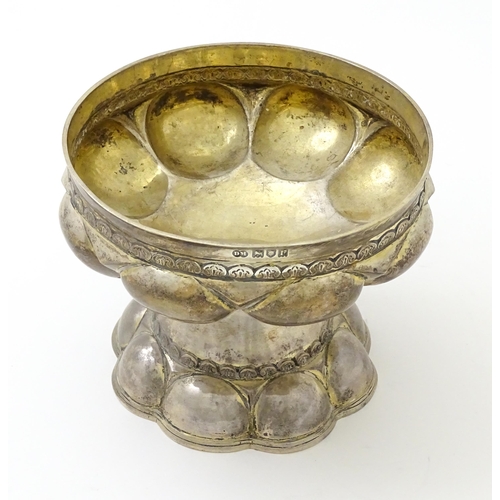 634 - A silver and silver gilt cup / chalice with Arts & Crafts style lobe decoration, hallmarked London 1... 