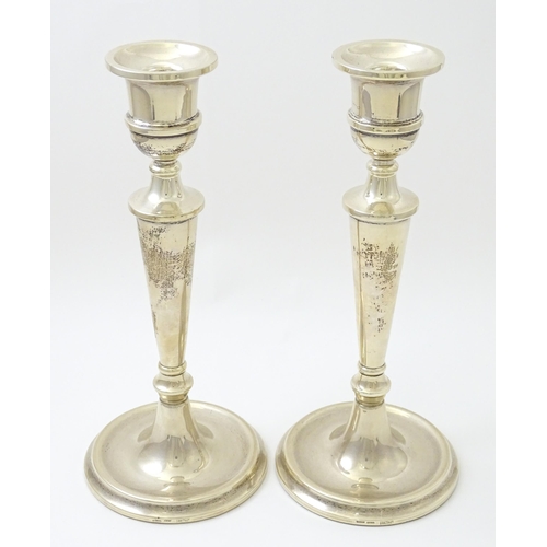 642 - A pair of silver candlesticks hallmarked Birmingham 1989, maker W. I. Broadway & Co. Approx. 10