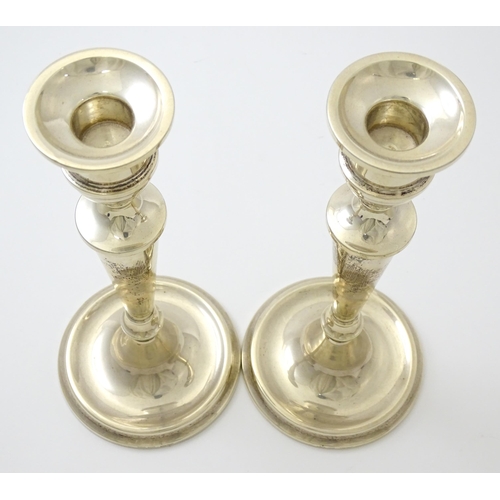 642 - A pair of silver candlesticks hallmarked Birmingham 1989, maker W. I. Broadway & Co. Approx. 10