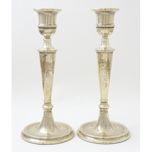 642 - A pair of silver candlesticks hallmarked Birmingham 1989, maker W. I. Broadway & Co. Approx. 10