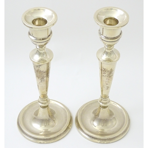 642 - A pair of silver candlesticks hallmarked Birmingham 1989, maker W. I. Broadway & Co. Approx. 10