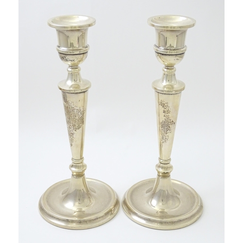 642 - A pair of silver candlesticks hallmarked Birmingham 1989, maker W. I. Broadway & Co. Approx. 10