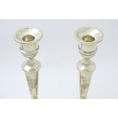 642 - A pair of silver candlesticks hallmarked Birmingham 1989, maker W. I. Broadway & Co. Approx. 10