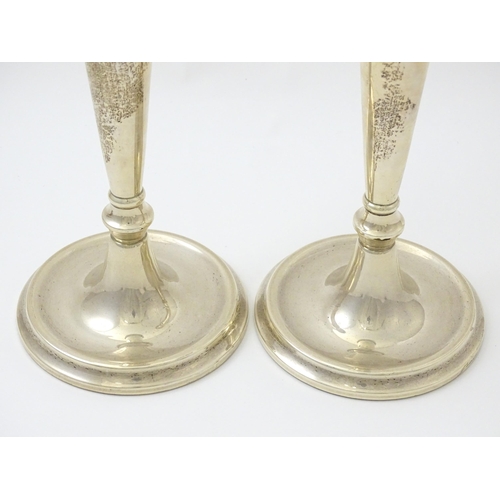 642 - A pair of silver candlesticks hallmarked Birmingham 1989, maker W. I. Broadway & Co. Approx. 10