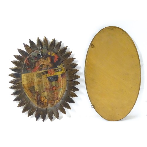 928 - Two oval mirrors with decorative frames, one with moulded depictions of fruits, the other with gilt ... 