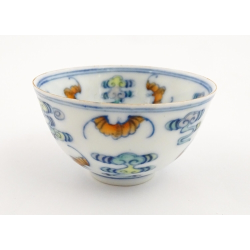 11 - A Chinese Docai tea bowl decorated with bats and stylised clouds. Character marks under. Approx. 2