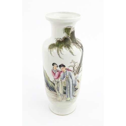 27 - A Chinese famille rose vase decorated with two female figures in a landscape, and Character script. ... 