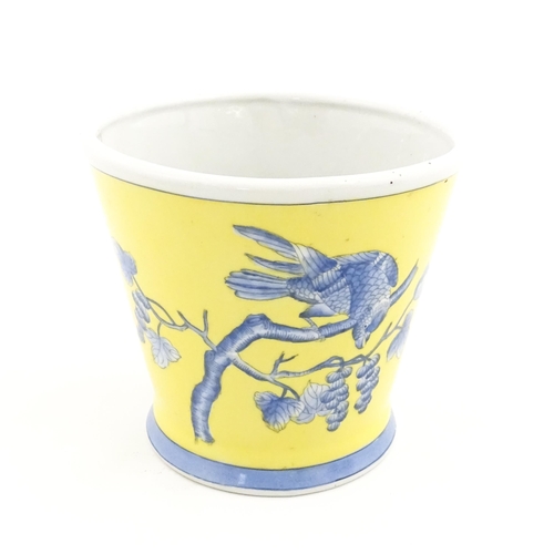 42 - A Chinese planter of tapering form with yellow ground and blue painted bird detail. Approx. 6