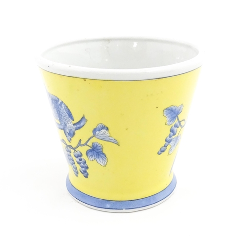 42 - A Chinese planter of tapering form with yellow ground and blue painted bird detail. Approx. 6