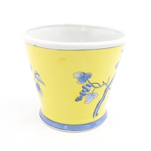 42 - A Chinese planter of tapering form with yellow ground and blue painted bird detail. Approx. 6