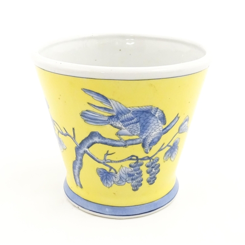 42 - A Chinese planter of tapering form with yellow ground and blue painted bird detail. Approx. 6