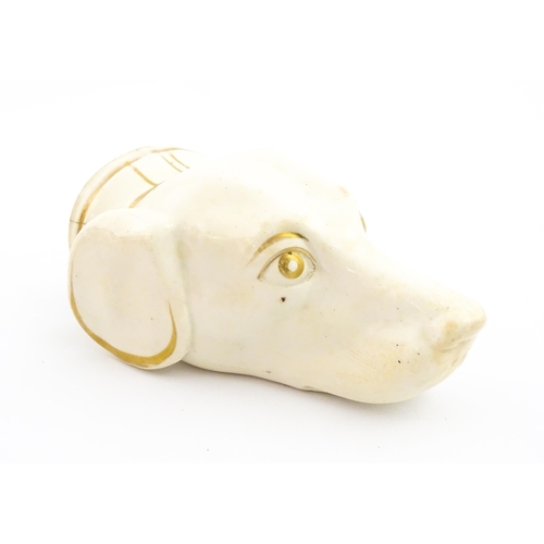 50 - A 19thC creamware stirrup cup of dog / hound head form with gilt detail. Approx. 4 3/4