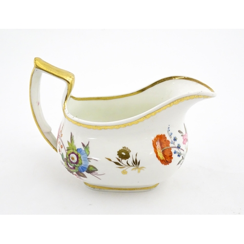 63 - An English cream jug with hand painted floral decoration and gilt highlights. Together with a pair o... 