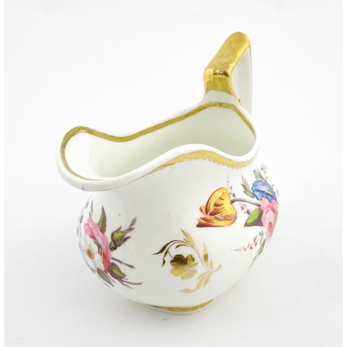 63 - An English cream jug with hand painted floral decoration and gilt highlights. Together with a pair o... 