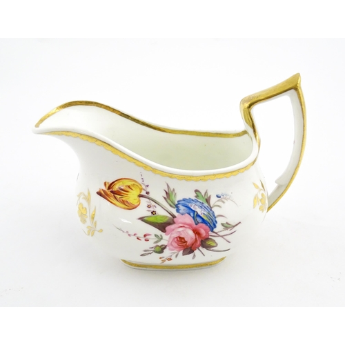 63 - An English cream jug with hand painted floral decoration and gilt highlights. Together with a pair o... 