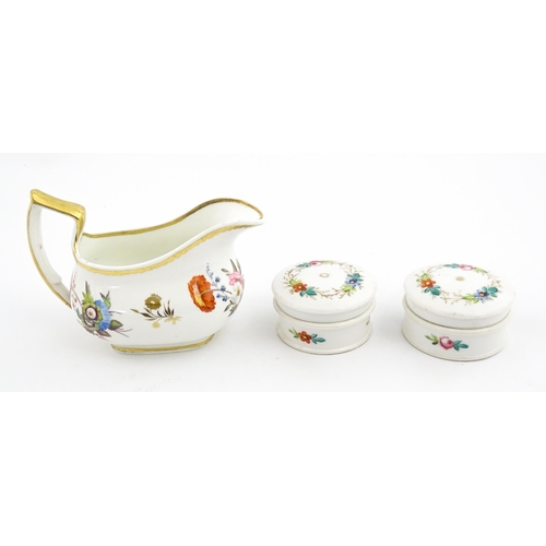 63 - An English cream jug with hand painted floral decoration and gilt highlights. Together with a pair o... 