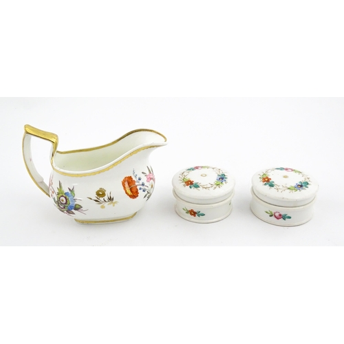 63 - An English cream jug with hand painted floral decoration and gilt highlights. Together with a pair o... 