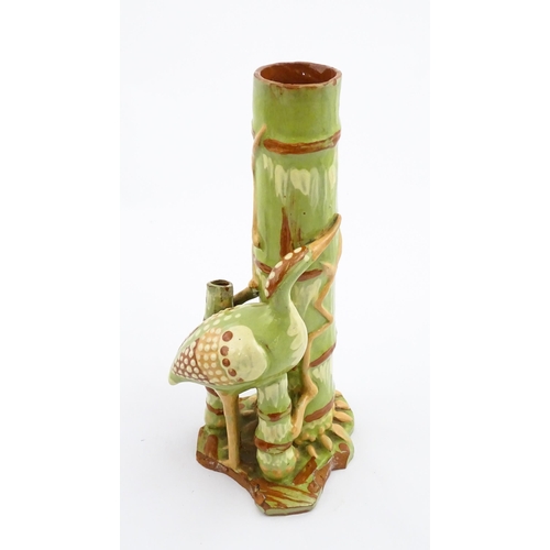 123 - A C. H. Brannam Barum art pottery spill vase of bamboo form with heron bird detail. Signed and dated... 