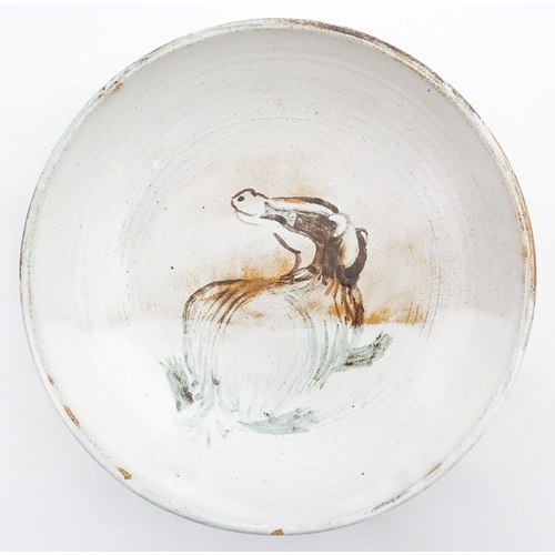 124 - A studio pottery stoneware bowl with hand painted decoration depicting a stylised badger. Approx. 8 ... 