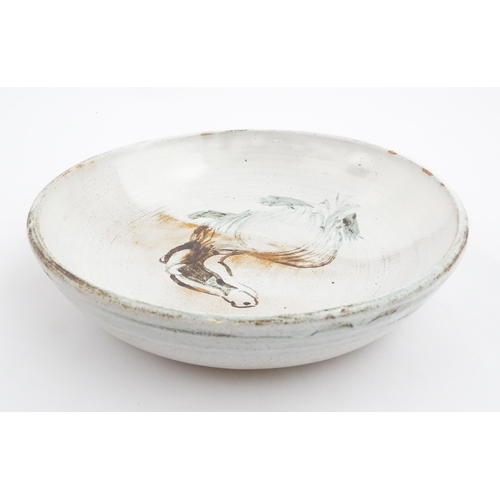 124 - A studio pottery stoneware bowl with hand painted decoration depicting a stylised badger. Approx. 8 ... 