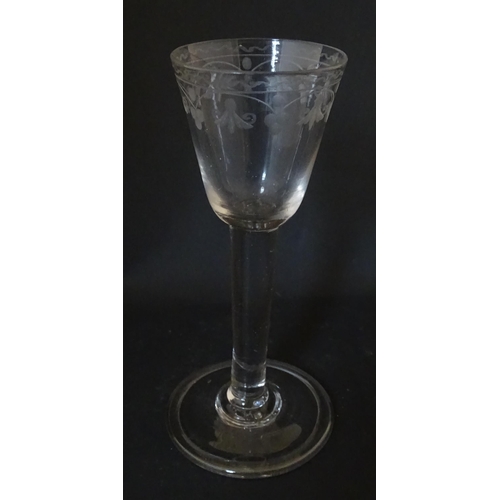 206 - A late 18thC drinking glass with etched floral decoration. Approx. 6