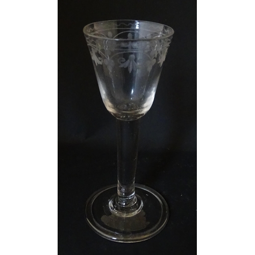 206 - A late 18thC drinking glass with etched floral decoration. Approx. 6