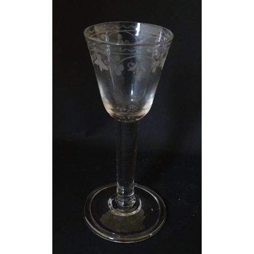 206 - A late 18thC drinking glass with etched floral decoration. Approx. 6