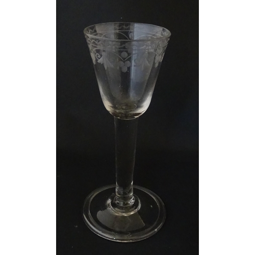 206 - A late 18thC drinking glass with etched floral decoration. Approx. 6