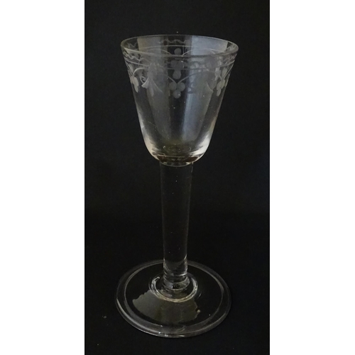 206 - A late 18thC drinking glass with etched floral decoration. Approx. 6