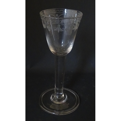 206 - A late 18thC drinking glass with etched floral decoration. Approx. 6